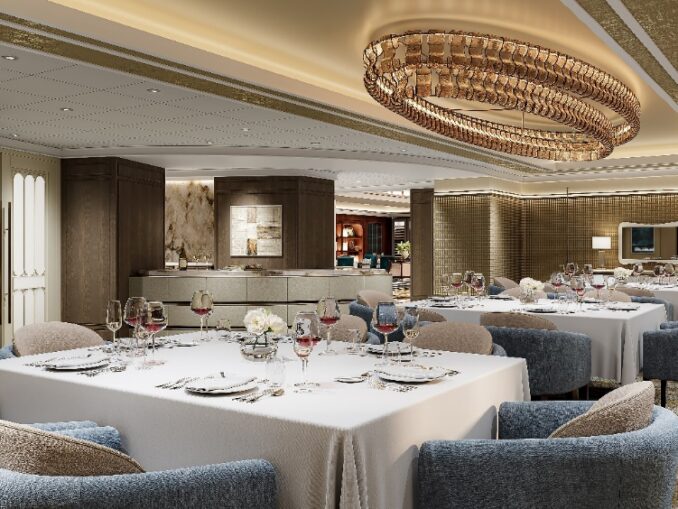 Elegant hotel dining room with white-tablecloth tables, blue upholstered chairs, and a large circular crystal chandelier overhead.