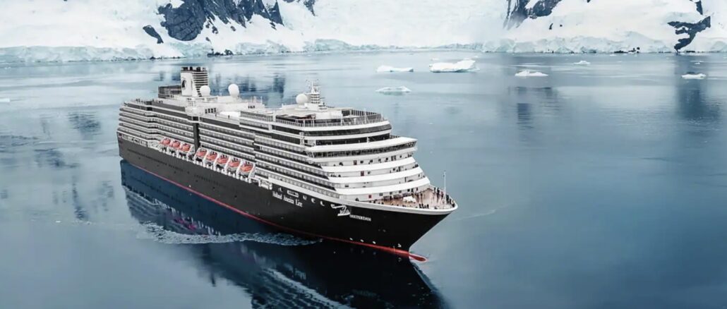 Large cruise ship sailing through icy Arctic waters with snow-covered cliffs in the background.