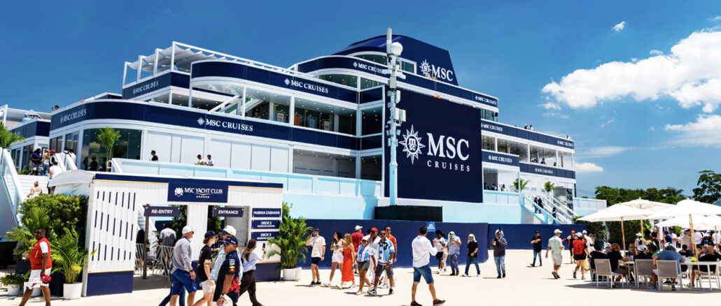 Multi-level MSC Cruises terminal building in blue and white with crowds outside on a sunny day.