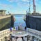 Cruise ship entering a canal lock, with tall concrete walls and cranes on the sides under a blue sky.